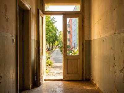 Open door leading to a bright new neighborhood